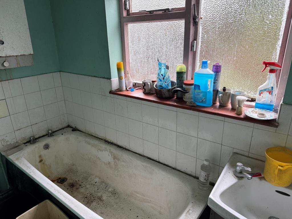 Lot: 168 - HOUSE IN NEED OF REFURBISHMENT - White bathroom and sink at rear of ground floor